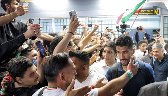 Iranian football fans receive their mens national football team upon their return from the 2026 Fifa World Cup, at Tehrans Mehrabad International Airport on July 1, 2026. — AFP
