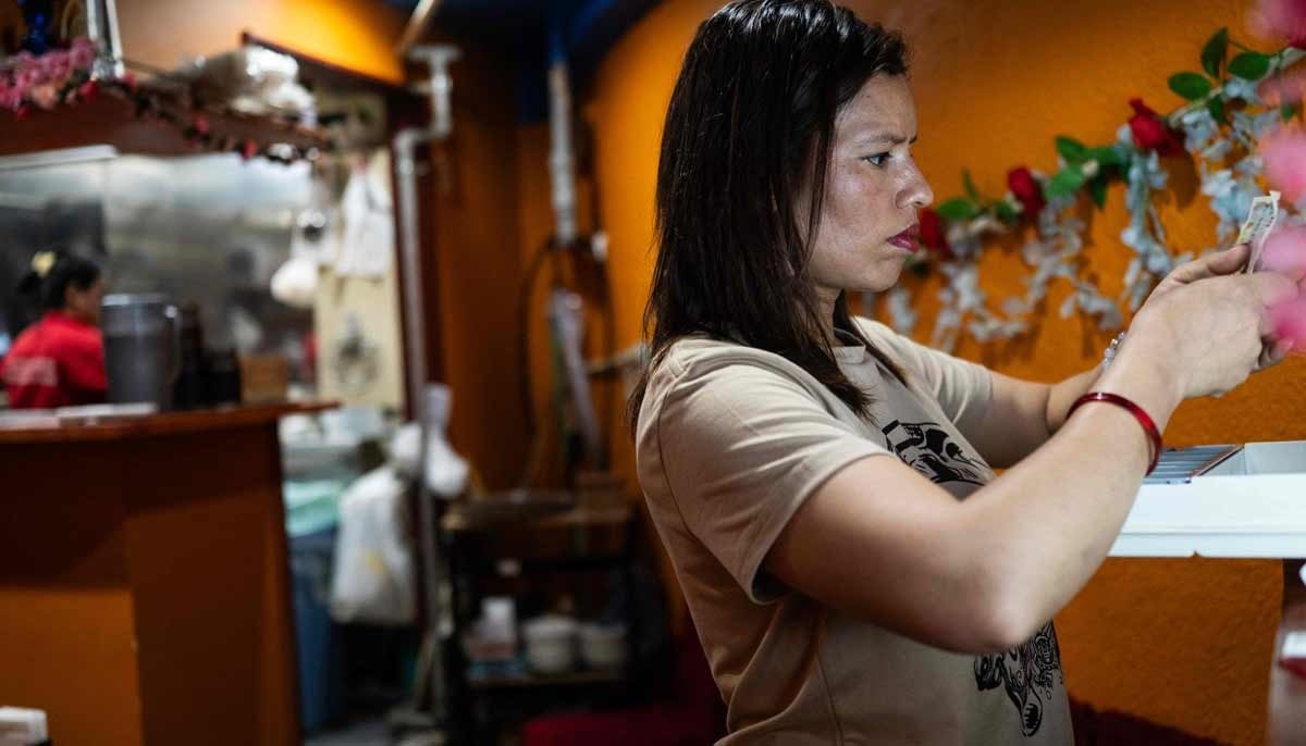 Budhathoki Samjhana, a restaurant owner and business manager visa holder at Chitwan Rhino Restaurant and Bar, checks receipts at her bar in the Okubo Shin area, one stop north of Shinjuku, in Tokyo on June 12, 2026. — AFP