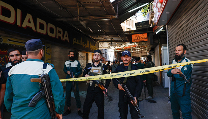Police officers stand at an area cordoned off with police tape near the site of what Syrian state media reported was a blast at a cafe in central Damascus, Syria, July 2, 2026. — Reuters