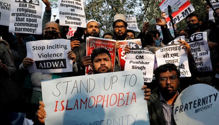 Demonstrators hold placards during a protest against what they say is hate speech against Muslims by Hindu leaders, in New Delhi, India, December 27, 2021. — Reuters