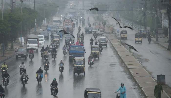 Commuters are passing through a road during the monsoon downpour in Karachi on August 23, 2025. — Online