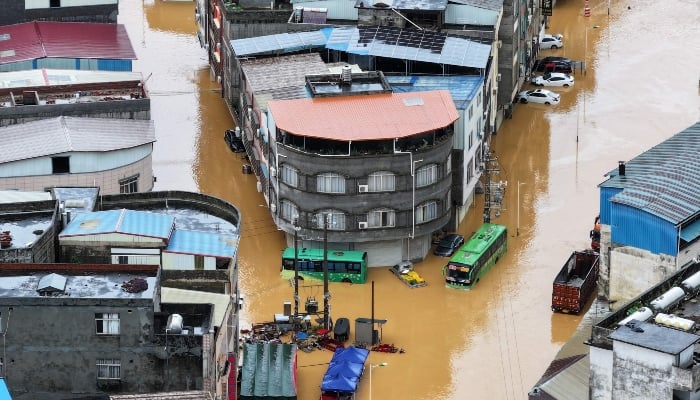 An aerial view shows flooding in Pingshan village at Xiaoyi town in Hengzhou, Chinas southern Guangxi region on July 6, 2026. — AFP