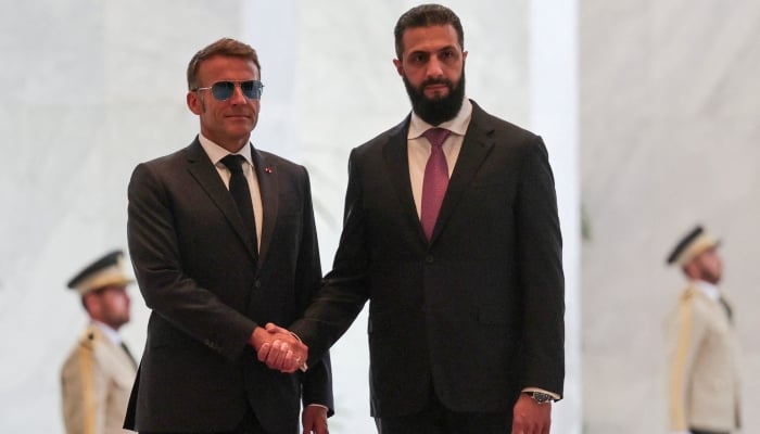 Frances President Emmanuel Macron shakes hands with Syrian President Ahmed Al-Sharaa at the Peoples Palace in Damascus, Syria, July 7, 2026. — Reuters