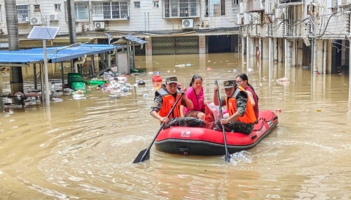 Paramilitary police officers evacuate residents in a rubber dinghy through a flooded area after rainfall brought by typhoon Maysak, in Nanning, Guangxi Zhuang Autonomous Region, China July 6, 2026. — AFP