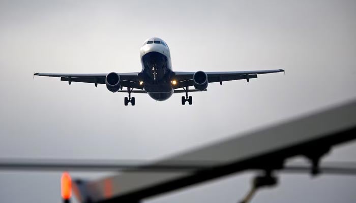 An airplane prepares to land at Cointrin airport in Geneva, Switzerland December 5, 2017. — Reuters