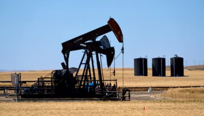 Oil pumpjacks and tanks are pictured in a farmer’s field near Kindersley, Saskatchewan, Canada September 5, 2024. — Reuters