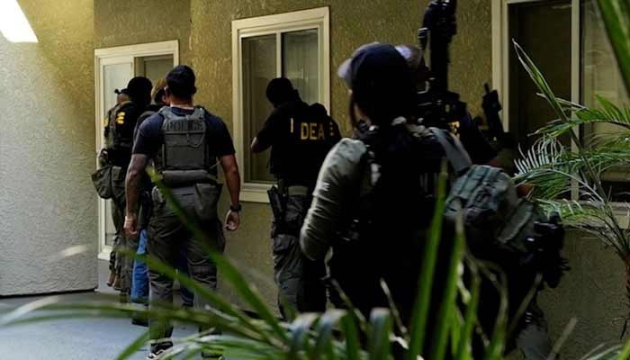 Law enforcement officers conduct one of a number of morning raids, before US and Canadian law enforcement officials announced federal charges and arrests of alleged members of a transnational organized crime group, in southern California, US July 7, 2026 in a still image from video. — Reuters