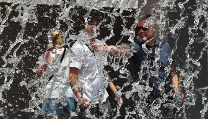 A man freshens up at a fountain as temperatures rise in Lisbon, Portugal, July 2, 2026. — Reuters