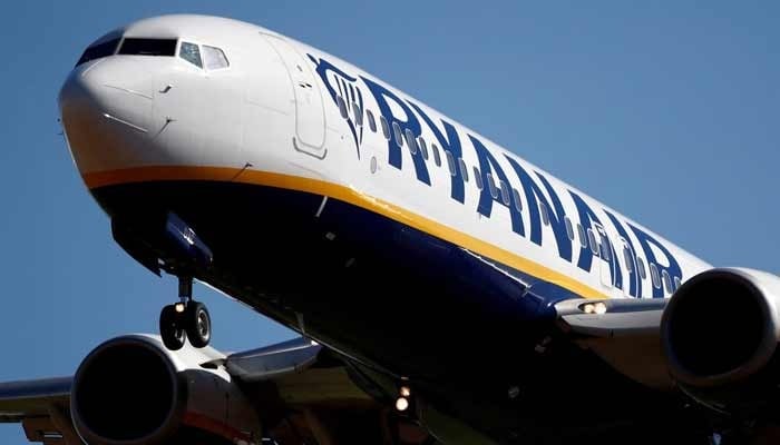 A Ryanair aircraft flies in the air in northern France on September 27, 2018. — Reuters