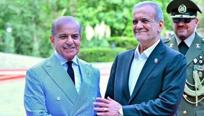 President of Iran Masoud Pezeshkian receives Prime Minister Shehbaz Sharif upon his arrival at Sadabad Palace, Iran. — APP/File