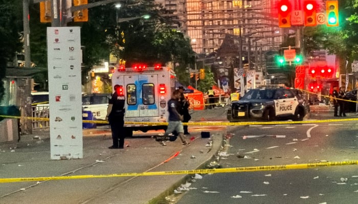 Police officers stand guard at the scene after a deadly shooting, at a salsa-themed street festival in Toronto, Ontario, Canada, July 11, 2026. — Reuters