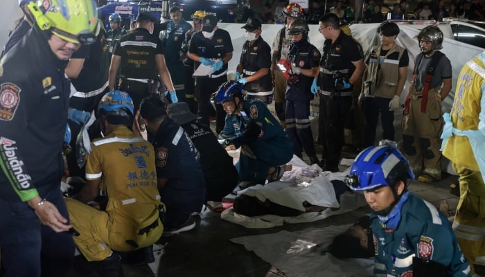 Members of emergency personnel work next to casualties at the site of a deadly fire at a pub in Bangkok, Thailand, July 13, 2026. — Reuters
