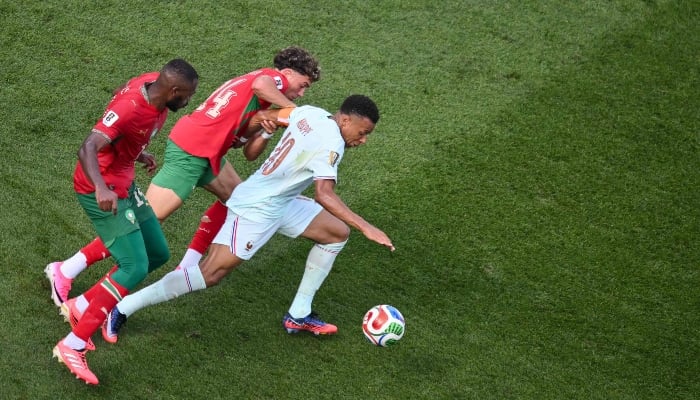Frances forward #10 Kylian Mbappe fights for the ball with Moroccos defender #14 Issa Diop and Moroccos midfielder #24 Neil El Aynaoui (C) during the 2026 World Cup football tournament quarter-final match between France and Morocco at Boston Stadium in Foxborough on July 9, 2026. — AFP