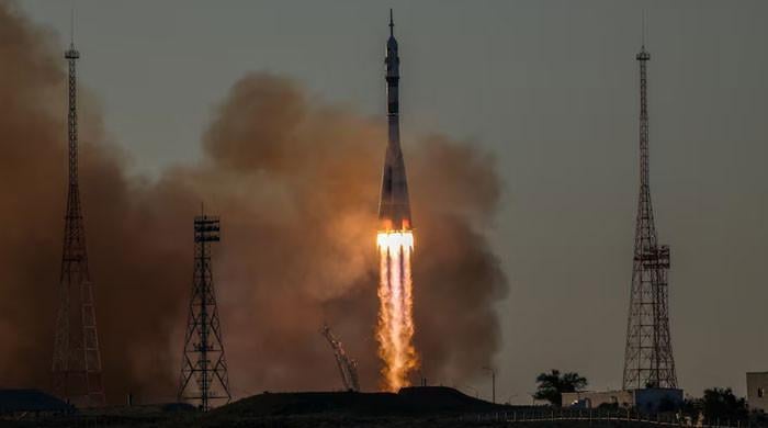 Russia sends American and two cosmonauts to space station 