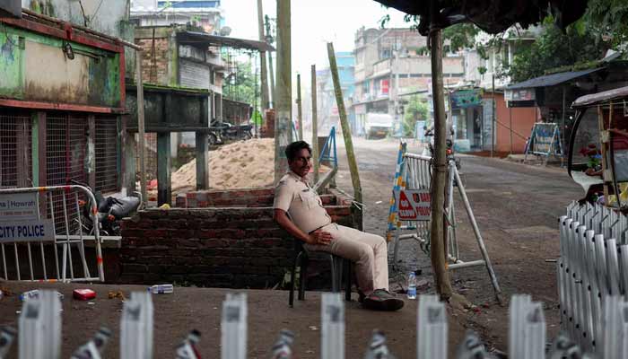 A police officer sits as he guards a street following the rape and murder of an 11-year-old girl in a town near Kolkata, West Bengal, India, July 11, 2026.— Reuters