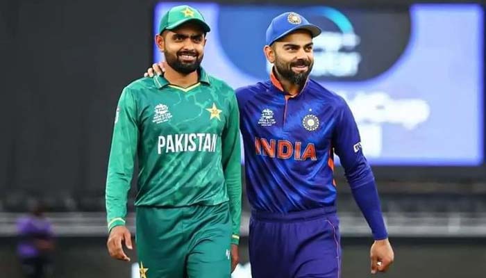 Babar Azam (left) and Indias Virat Kohli take a walk on the pitch before the start of the ICC mens T20 World Cup cricket match at the Dubai International Cricket Stadium on October 24, 2021. — Reuters
