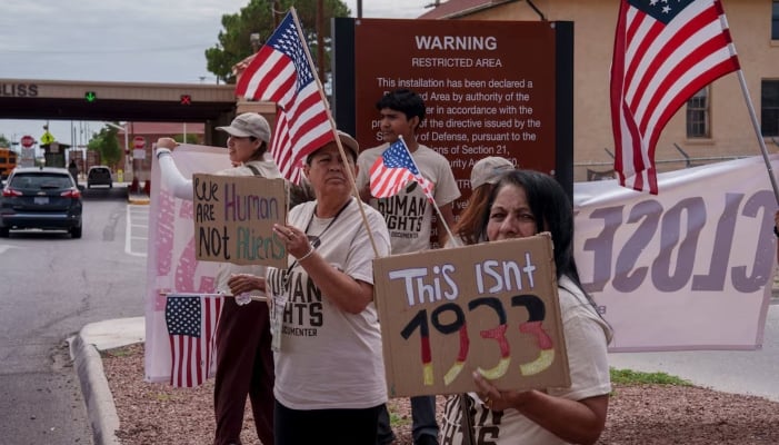 Protesters opposing mass deportations by ICE hold signs during a protest held at the Cassidy Gate at Fort Bliss, the US Army base where a large new ICE detention facility is being built, in El Paso, Texas, US, August 17, 2025. — Reuters