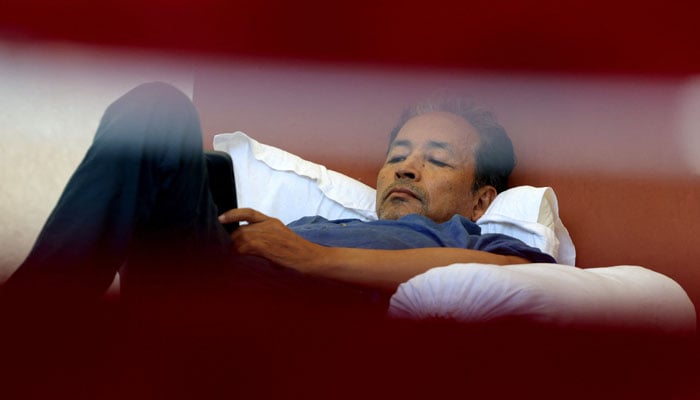 Sonam Wangchuk, an Indian education reformer who has been on hunger strike, rests on stage during a sit-in protest called by CJP demanding the resignation of Indian Education Minister Dharmendra Pradhan, at Jantar Mantar in New Delhi, India, July 14, 2026. — Reuters