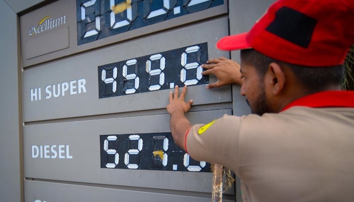 An employee of a petrol station updates the latest fuel prices on a board in Karach, Pakistan, 03 April 2026. — INP