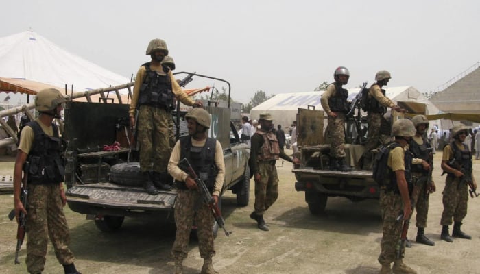 Pakistani soldiers stand guard in Bannu, Khyber-Pakhtunkhwa, on July 2, 2014. — Reuters