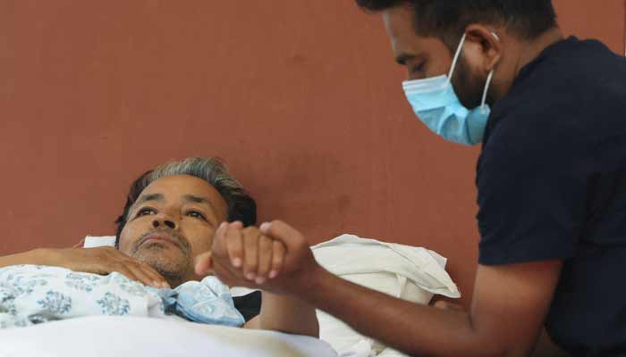 Abhijeet Dipke, head of the Cockroach Janta Party (CJP), holds the hand of Sonam Wangchuk, an Indian education reformer at Jantar Mantar in New Delhi, India, July 18, 2026. — Reuters