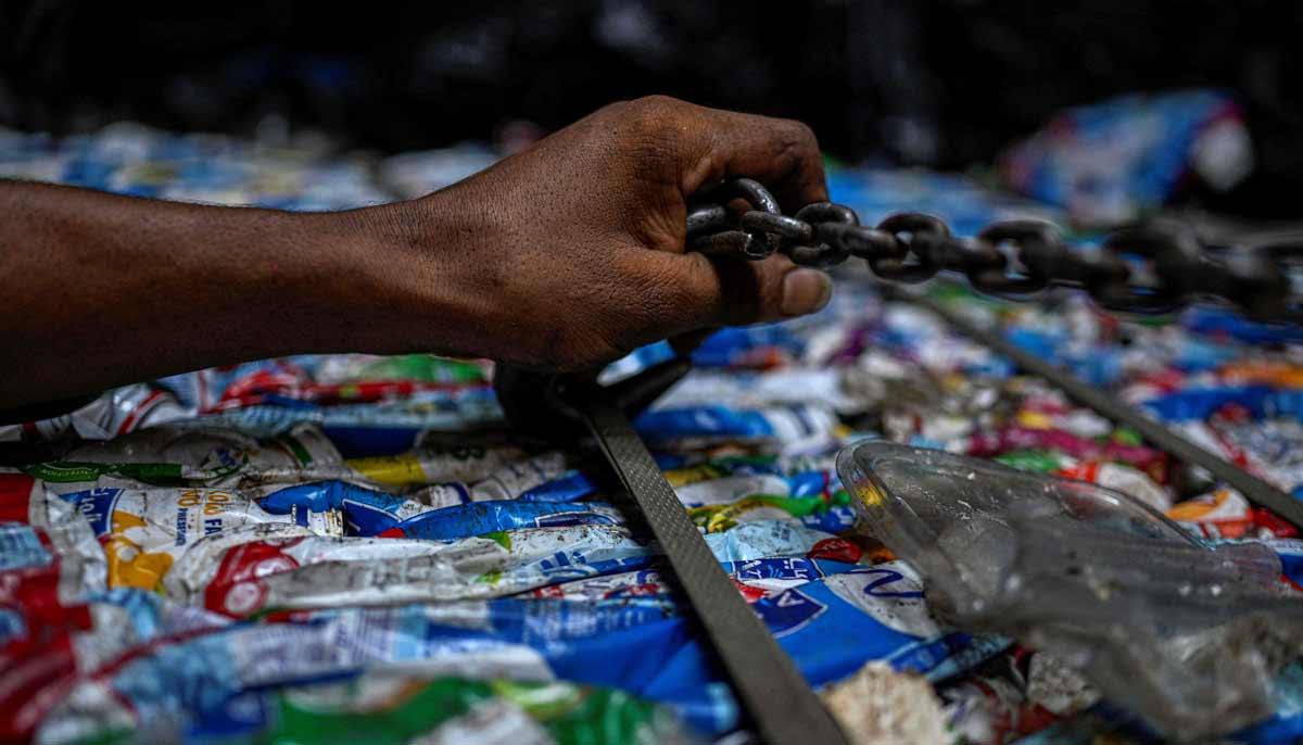 An Egyptian worker scures a bail of plastic before loading on a truck for recycling at the garbage city in the Manshiyet Nasser neighbourhood in Cairo on July 6, 2026.— AFP