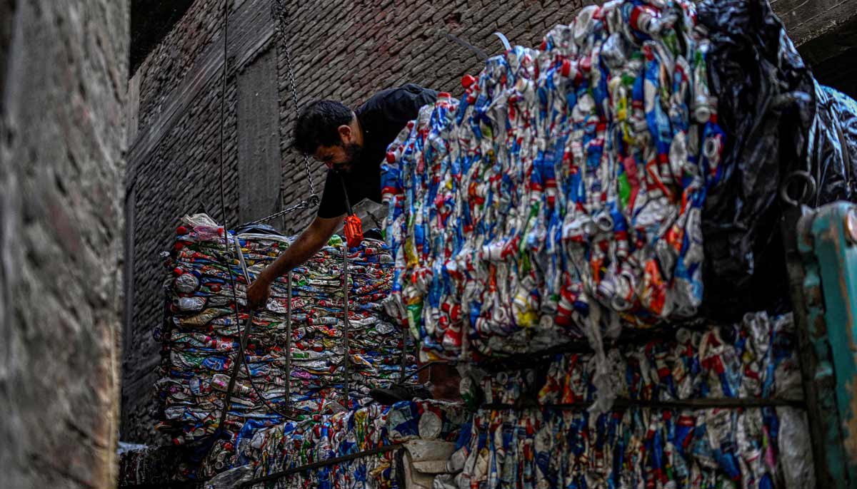 An Egyptian worker loads bails of plastic for recycling on a truck at the garbage city in the Manshiyet Nasser neighbourhood in Cairo on July 6, 2026.— AFP