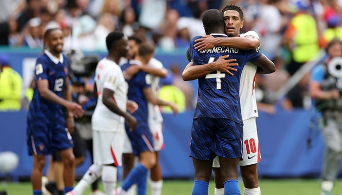 Jude Bellingham #10 of England embraces with Dayot Upamecano #4 of France after the 6-4 win during the Fifa World Cup 2026 Bronze Final between France and England at Miami Stadium on July 18, 2026 in Miami Gardens, Florida. — AFP
