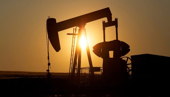 An oil pump jack pumps oil in a field near Calgary, Alberta, Canada on July 21, 2014. — Reuters
