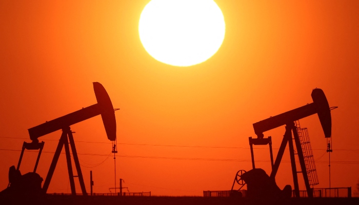 The sun sets behind oil pumps outside Vaudoy-en-Brie, near Paris, France, March 18, 2026. — Reuters
