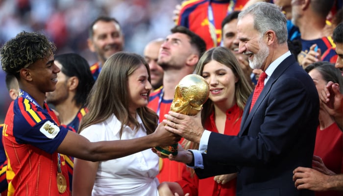 Spains Lamine Yamal (left) gives the trophy to Spains King Felipe VI after winning the Fifa World Cup as Spains Leonor, Princess of Asturias and Infanta Sofia look on at York/New Jersey Stadium, East Rutherford, New Jersey, US, July 19, 2026. — Reuters