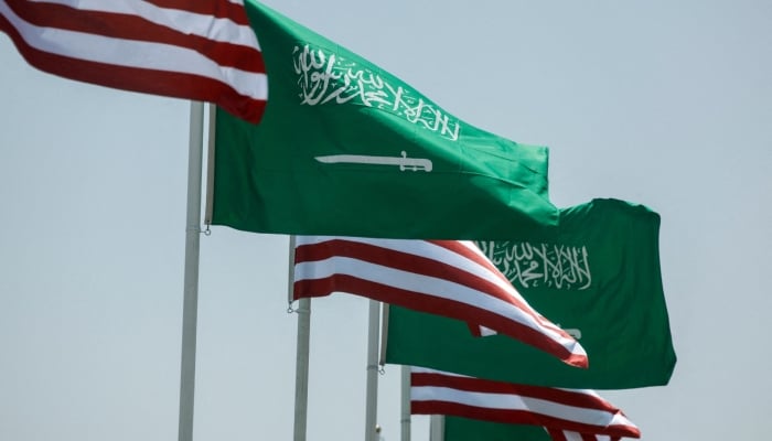 US and Saudi flags flutter along a highway of Riyadh, as pictured through the glass of a car, ahead of the arrival of US President Donald Trump to Riyadh, Saudi Arabia May 12, 2025. — Reuters