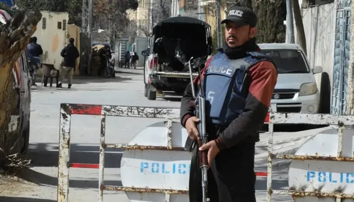 The image shows a police officer holding weapon in his hand. — AFP/File