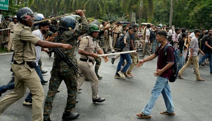 Police officers wield batons against a supporter of the All India Students Association (AISA) during a protest demanding accountability for police action against students at a march by supporters of the Cockroach Janta Party (CJP) towards parliament in Delhi on July 20, 2026. — Reuters