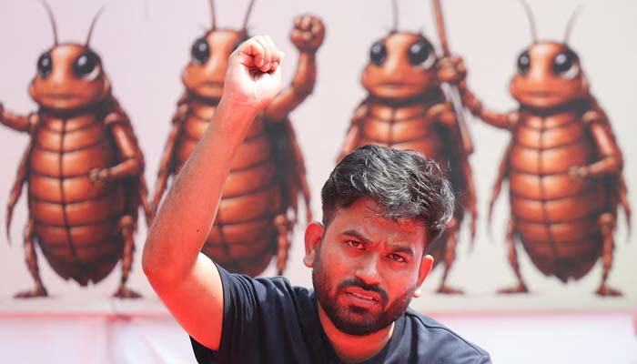 Abhijeet Dipke, head of the Cockroach Janta Party (CJP), gestures to the supporters of the CJP during a sit-in protest demanding the resignation of Indian Education Minister Dharmendra Pradhan, in New Delhi, India, June 20, 2026. — Reuters