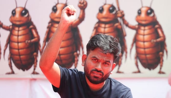 Abhijeet Dipke, head of the Cockroach Janta Party (CJP), gestures to the supporters of the CJP during a sit-in protest demanding the resignation of Indian Education Minister Dharmendra Pradhan, in New Delhi, India, June 20, 2026. — Reuters