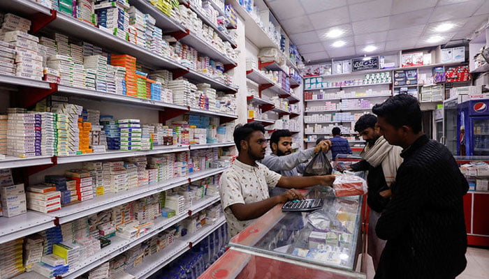 Customers buy medicine from medical store in Karachi Pakistan. — Reuters
