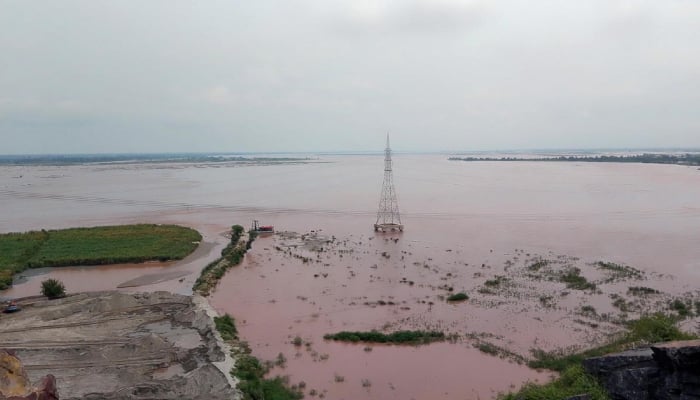 A view of the Chenab River as floodwater spreads across the river channel and inundates the adjoining banks following a rise in the water level, July 24, 2026. — APP