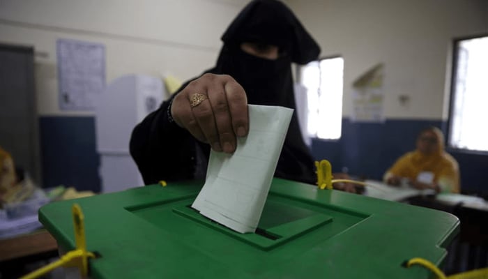 A woman casts her vote at a polling station during the general election in Islamabad on July 25, 2018. — Reuters