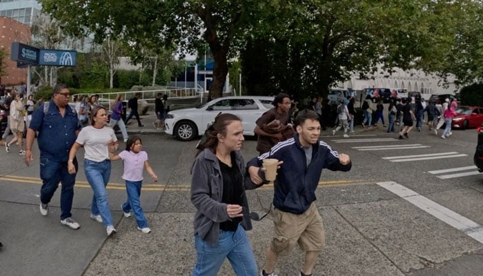 People rush to take cover during an incident that Seattle Police described as a shooting with multiple victims at Seattle Center, which was hosting a Bite of Seattle food festival, in Seattle, Washington, US, July 26, 2026.— Reuters