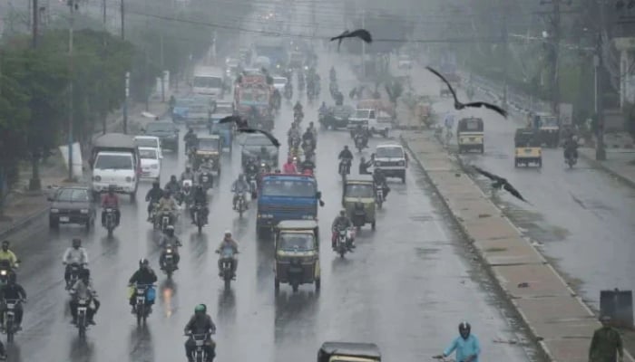 Commuters are passing through a road during the downpour of the monsoon in Karachi on August 23, 2025. — Online