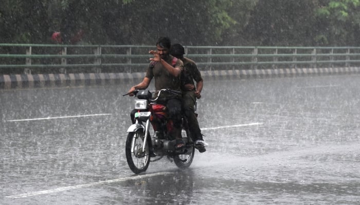 A motorcyclist makes his way through heavy rain in Lahore, July 25, 2026. — APP