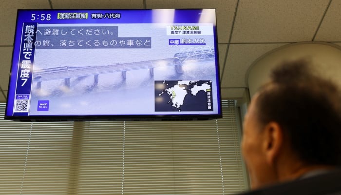 A television screen reporting a collapsed bridge after an earthquake with a preliminary magnitude of 7.1 struck Japans southern Kumamoto Prefecture in Tokyo, Japan, July 28, 2026. — Reuters