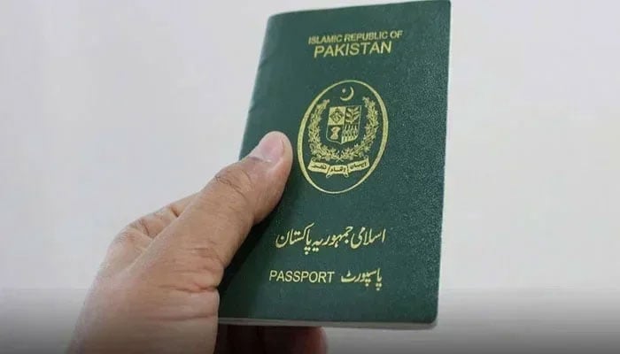 This photo shows a person holds a Pakistani passport. — APP/File