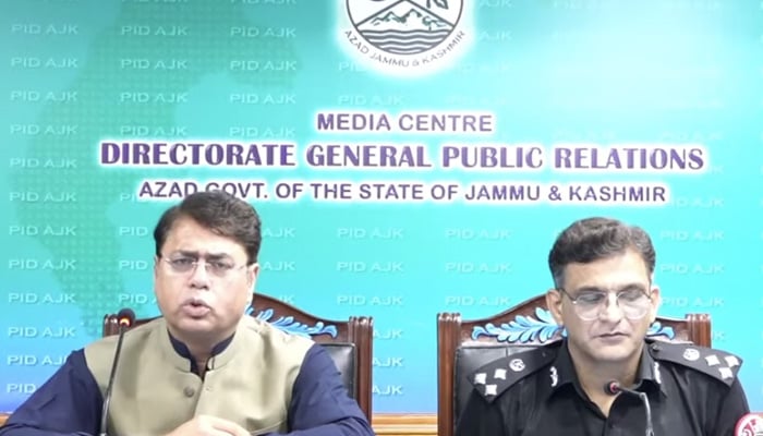 AJK Secretary Information Muhammad Rashid Hanif and regions police spokesperson DIG Irfan Masood Kashfi address a press conference in Muzaffarabad on July 28, 2026. — Screengrab via Geo News