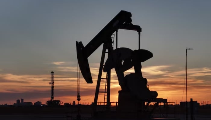 A drone view of a pump jack and drilling rig south of Midland, Texas, US June 11, 2025. — Reuters