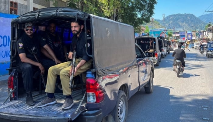 Police officers sit in a vehicle as they patrol for security measures ahead of a strike call by banned Joint Awami Action Committee (JAAC) in Muzaffarabad, Azad Jammu and Kashmir, June 8, 2026. — Reuters
