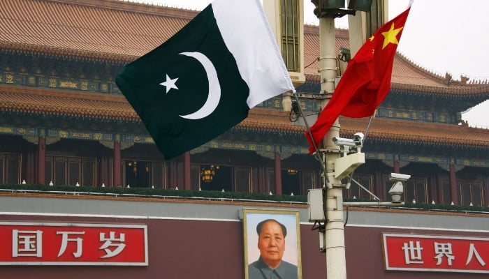 A Pakistani national flag flies alongside a Chinese national flag in front of the portrait of Chairman Mao Zedong on Beijing’s Tiananmen Square. — Reuters