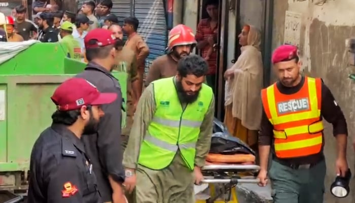 Rescue personnel carry a body on a stretcher after the roof of a house collapsed near Sukh Nehr in Lahore’s Baghbanpura area, on July 30, 2026. — Truth Wire