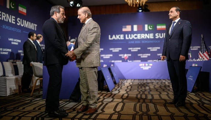 Irans Foreign Minister Abbas Araghchi (L) shakes hands with Prime Minister Muhammad Shehbaz Sharif (C) next to Chief of Army Staff Field Marshal Asim Munir (R) at the Burgenstock luxury hotel complex overlooking Lake Lucerne, Switzerland, on June 21, 2026
